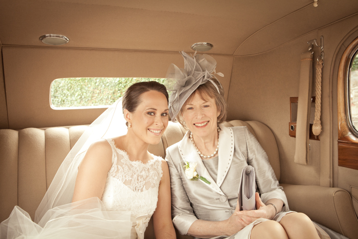 bride and mother of the bride in wedding car bride and mother of the bride in car
